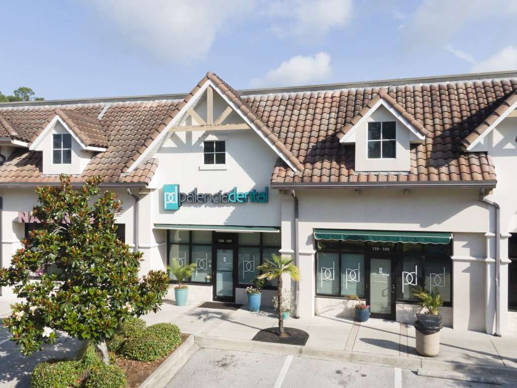 A wide-angle view of the Palencia Dental office exterior, featuring a tiled roof building with the Palencia Dental sign above the entrance – Palencia Dental
