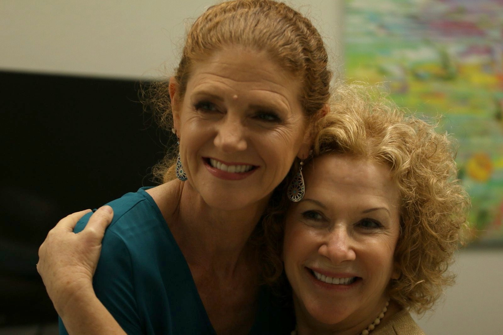 Dr. Stephanie Kinsey and a smiling patient sharing a hug at Palencia Dental in St. Augustine