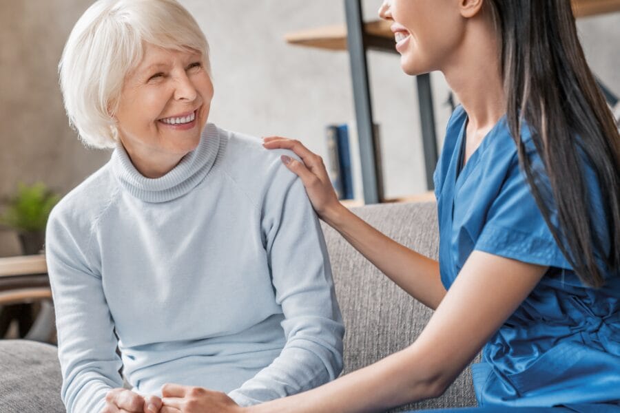 Smiling elderly woman engaging with a compassionate female dental professional, highlighting trust, comfort, and the patient-first philosophy at Palencia Denta